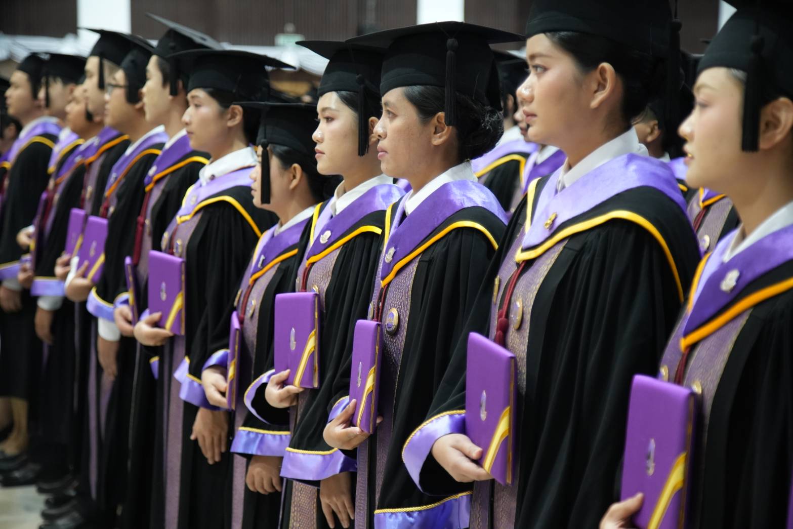 Graduates in academic gowns lined up during the University of Phayao graduation ceremony