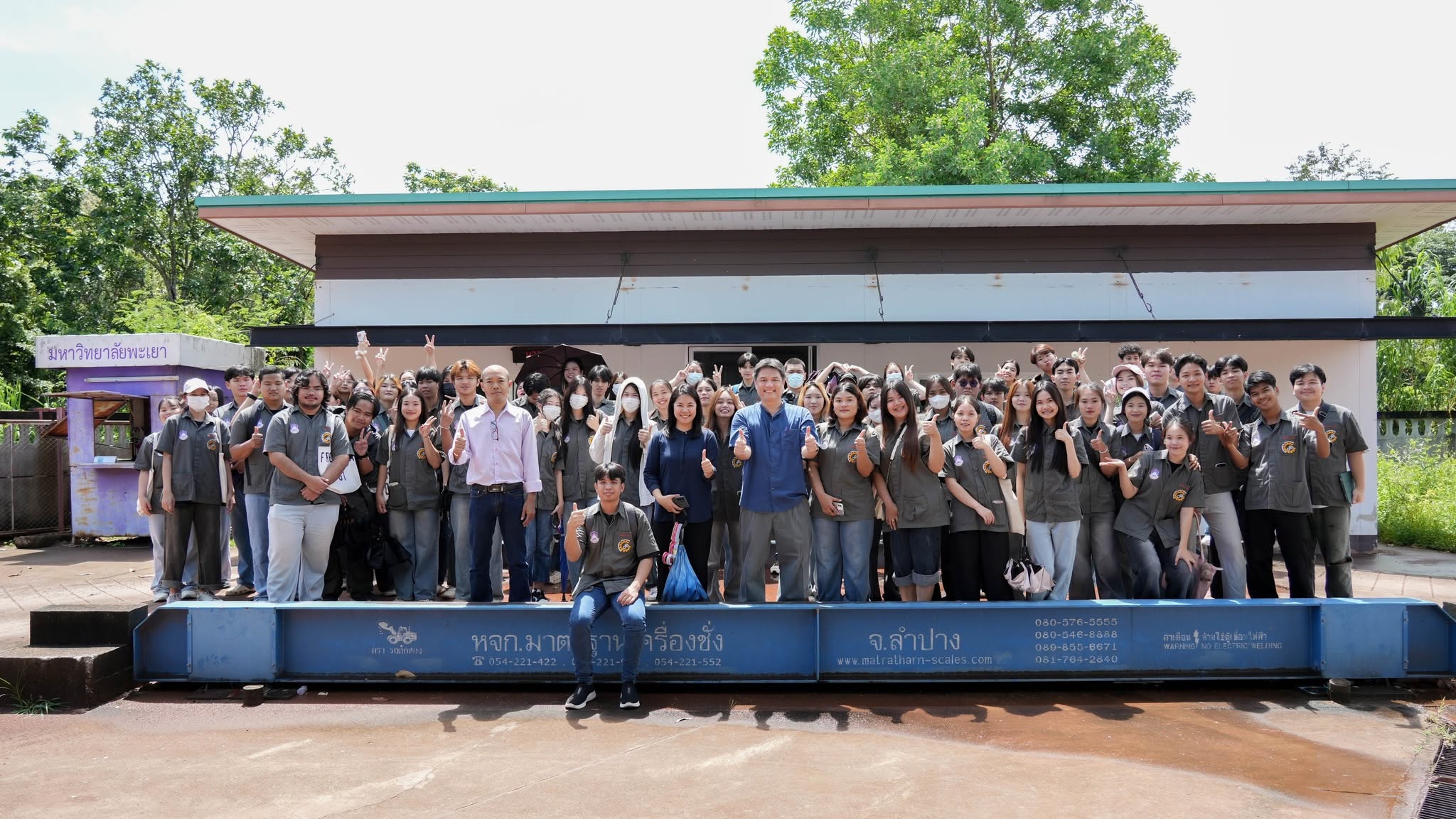 Students with umbrellas during a waste management course field visit