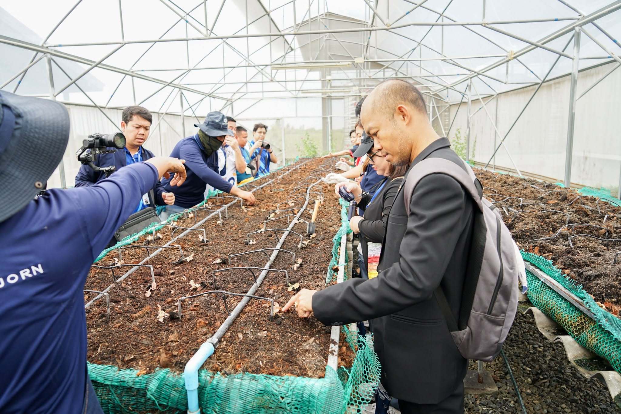 Delegation visiting a composting facility as part of a sustainability study program