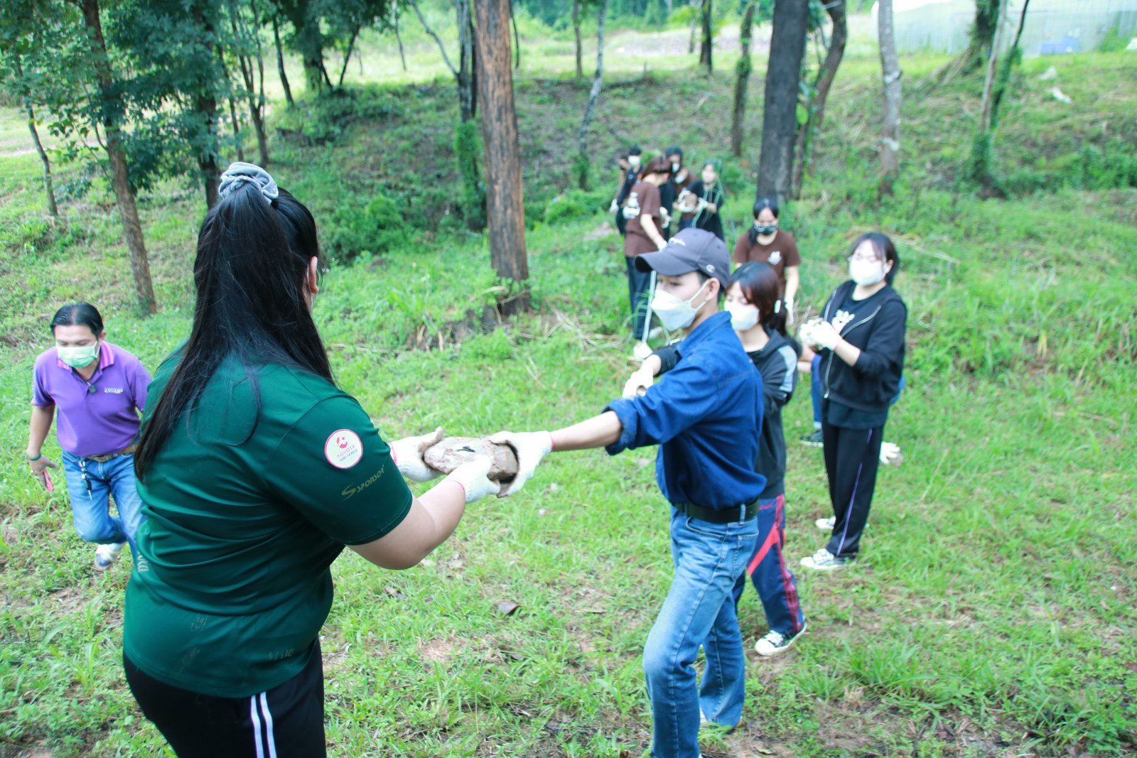 Volunteers building a stream check dam as part of environmental literacy activities