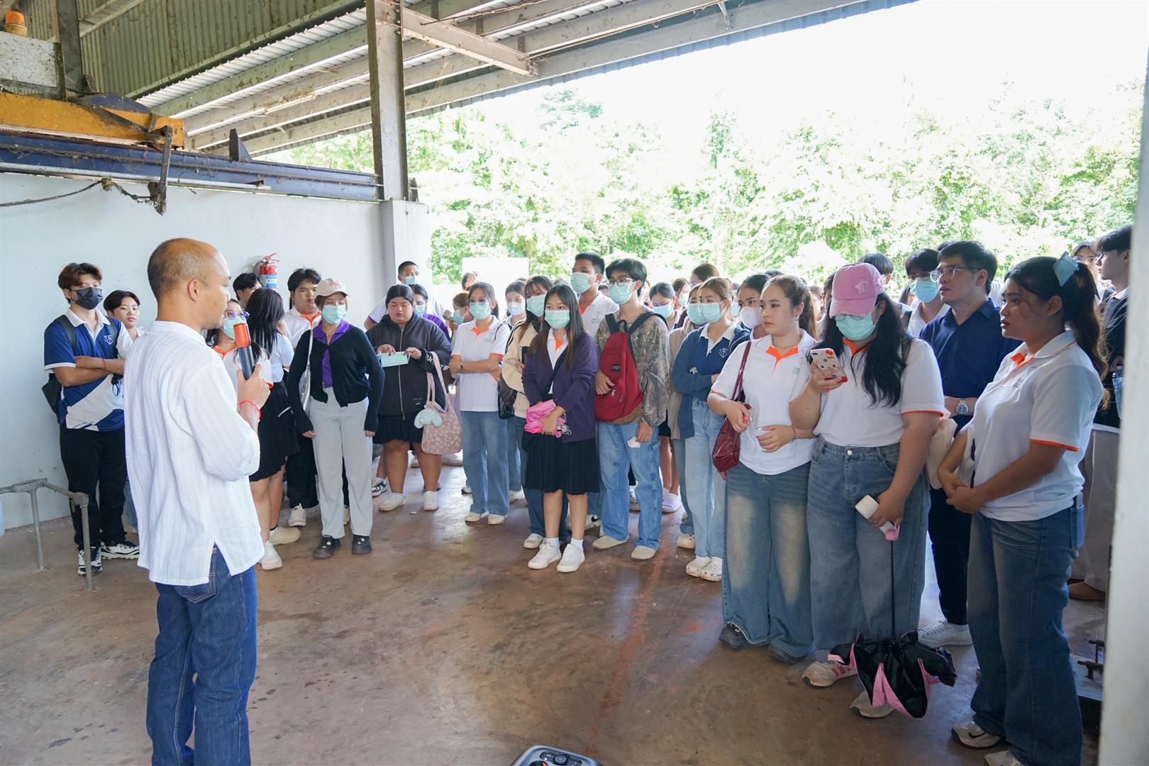 Students gathered at a facility during a sustainability study program visit
