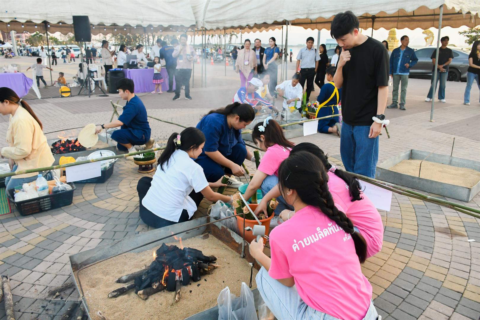 Participants roasting Khao Lam at the Traditional Khao Lam Roasting Competition 2026