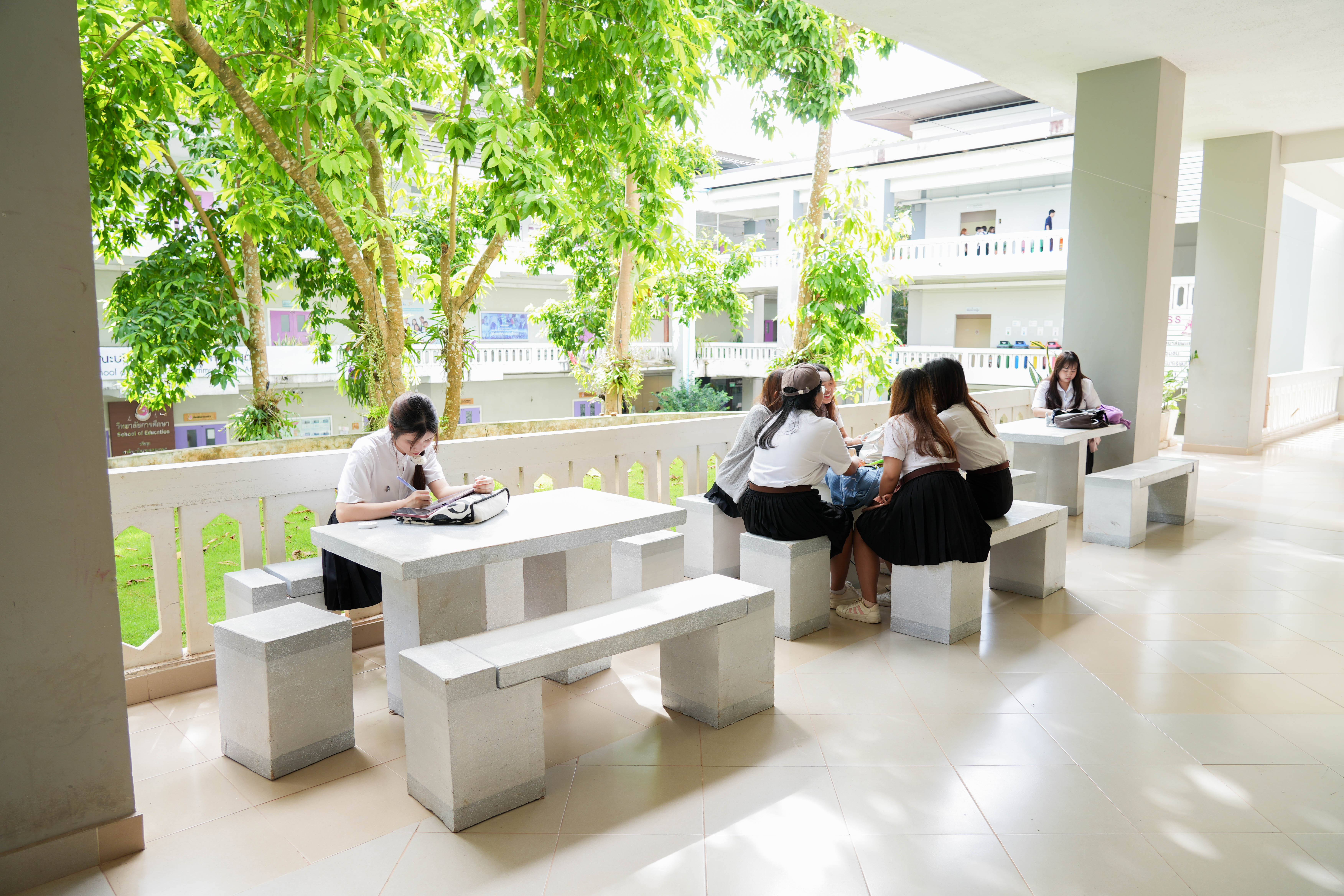 Students studying in a naturally ventilated open corridor, University of Phayao
