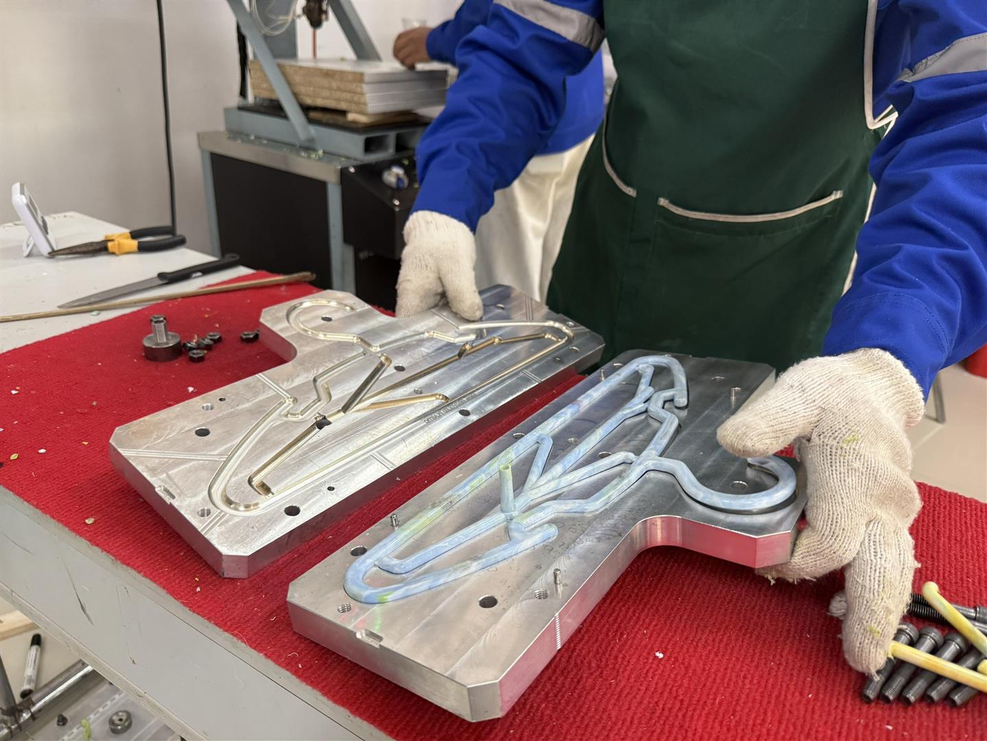 University staff producing coat hangers from recycled plastic