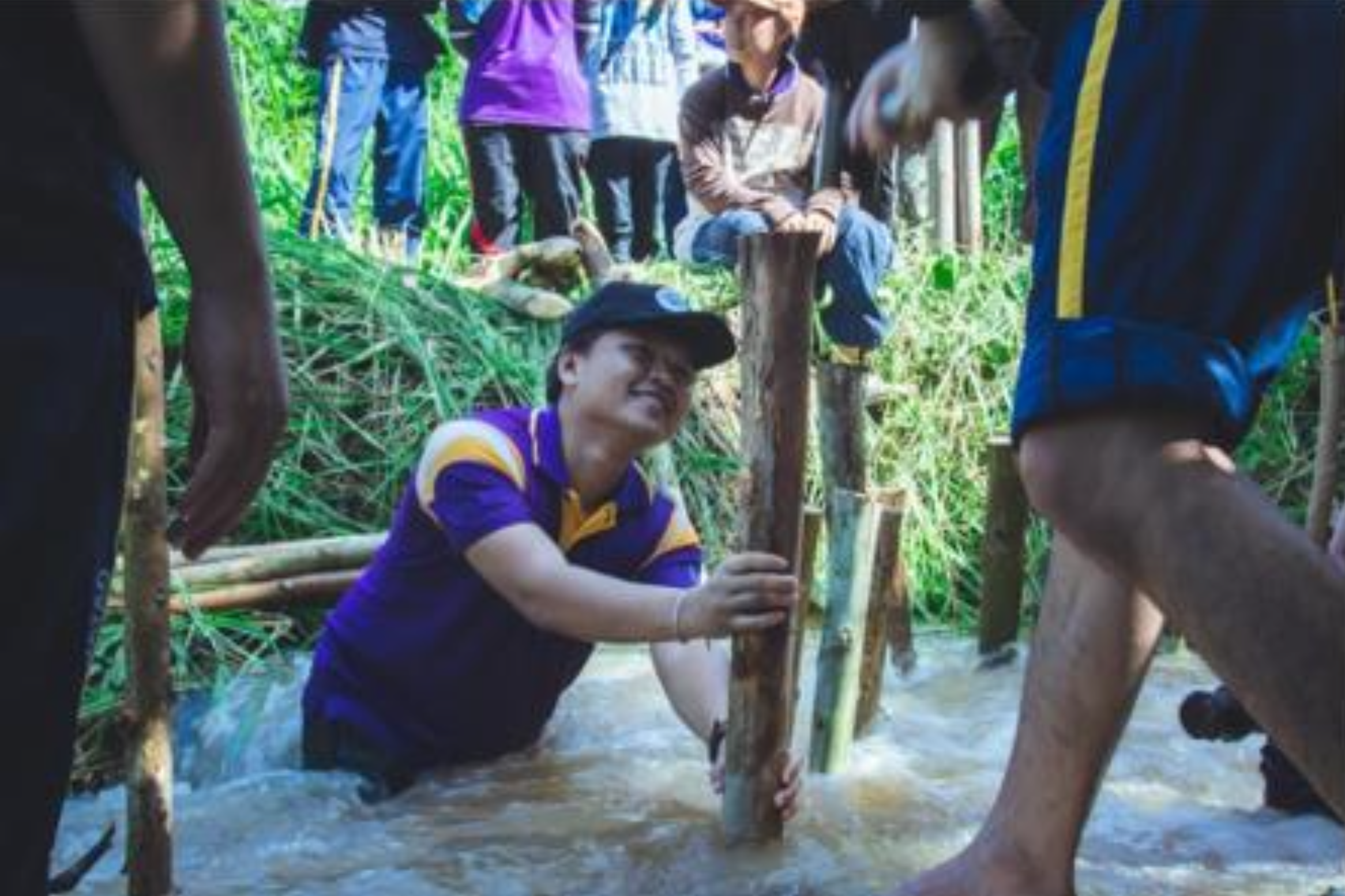 University of Phayao students and community members building a check dam in a stream