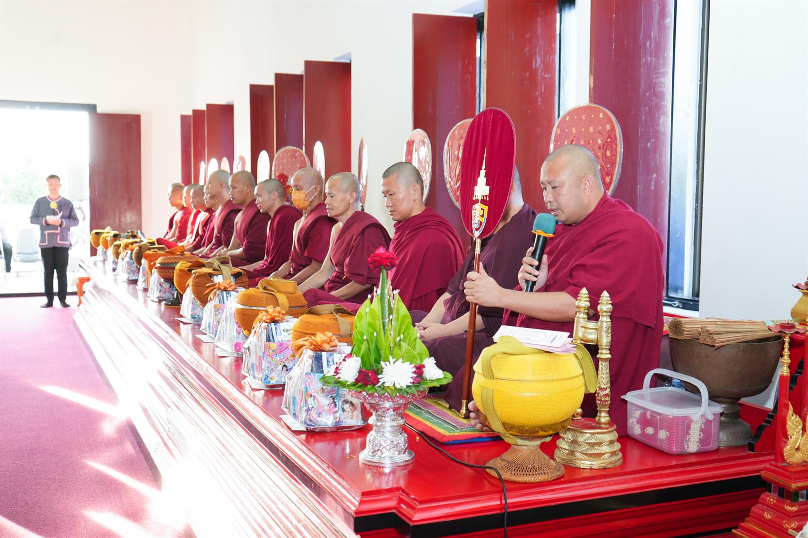 Monks receiving alms offerings at the Annual Tak Bat Devo Ceremony 2025